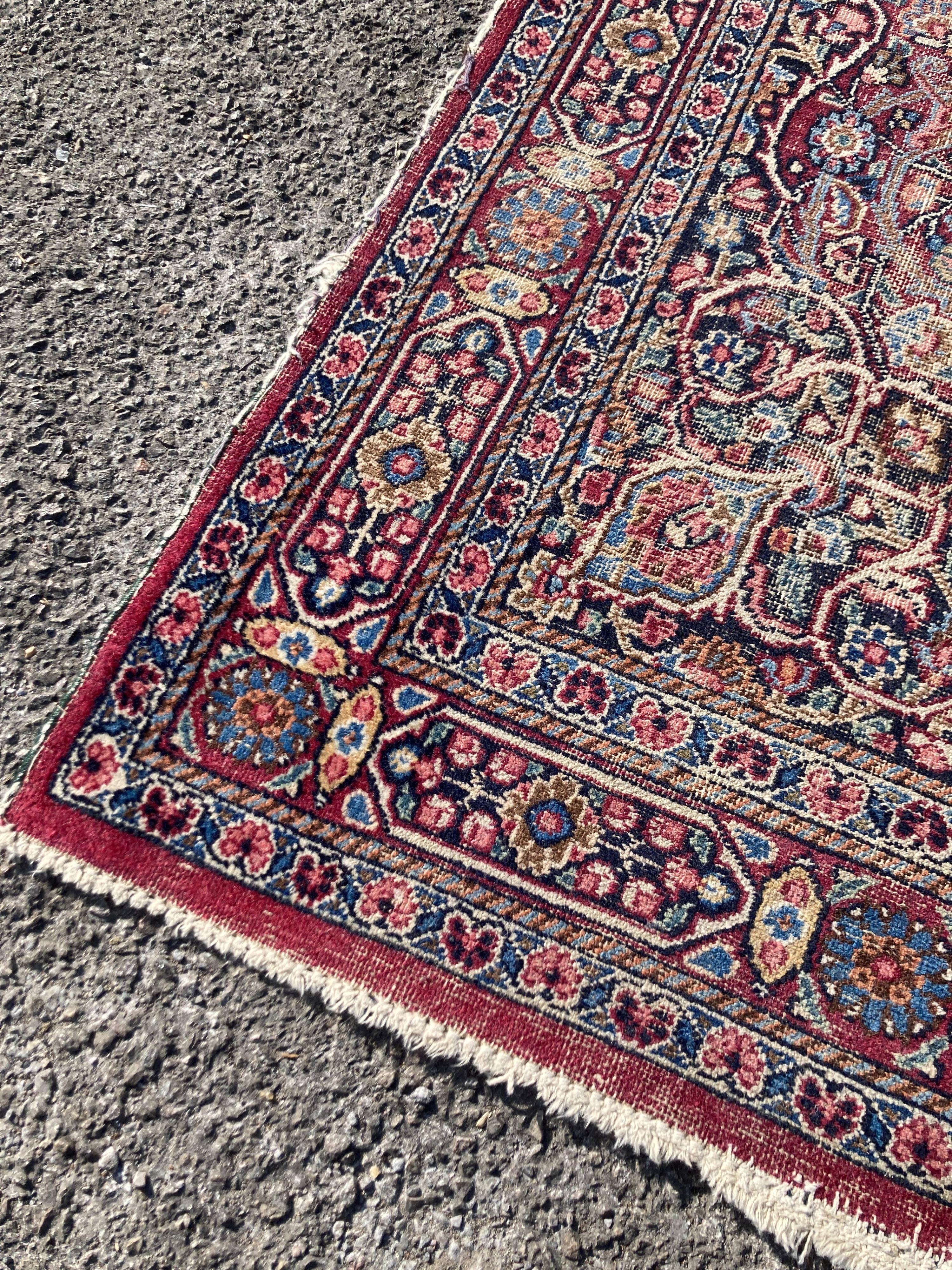A North West Persian red ground rug (worn), 127 x 76cm